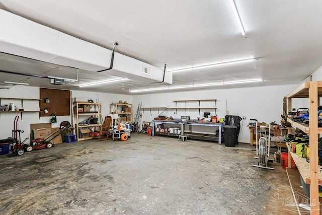 4662 Oakland Dr, Pensacola, FL 32526 - garage featuring a workshop area and a garage door opener