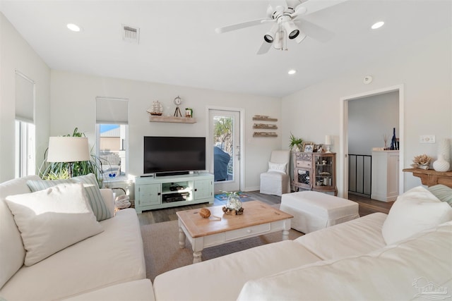 living room featuring hardwood / wood-style flooring, ceiling fan, and plenty of natural light