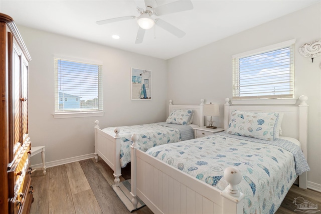 bedroom with hardwood / wood-style floors and ceiling fan