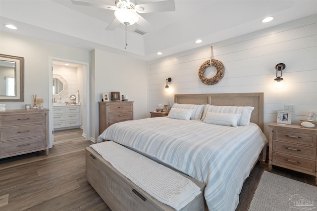 bedroom featuring ensuite bathroom, ceiling fan, and dark hardwood / wood-style flooring