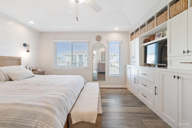 bedroom with dark hardwood / wood-style floors and ceiling fan