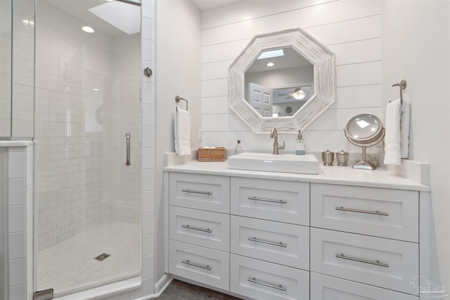 bathroom featuring vanity and a shower with shower door