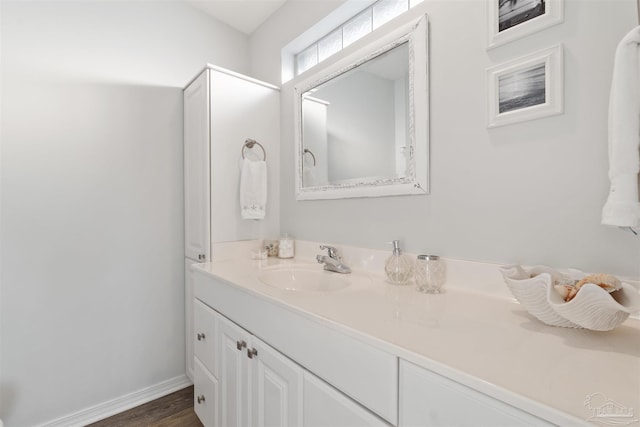 bathroom with hardwood / wood-style flooring and vanity