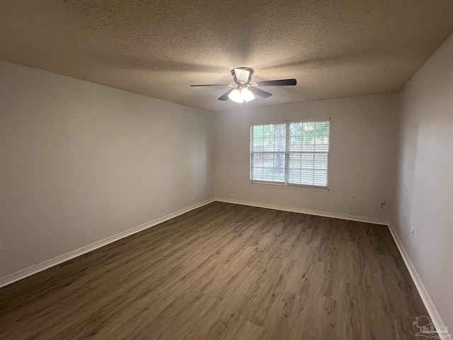 4888 La Casa Cir, Pace, FL 32571 - empty room with dark wood-type flooring, a textured ceiling, ceiling fan, and baseboards