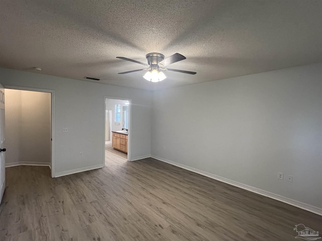 4888 La Casa Cir, Pace, FL 32571 - empty room featuring dark wood finished floors, ceiling fan, a textured ceiling, and baseboards