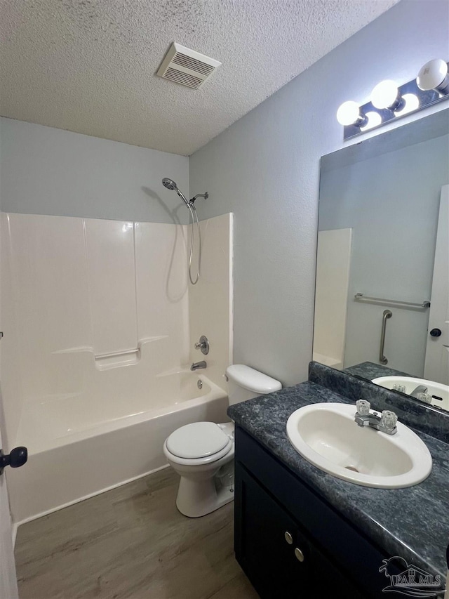 4888 La Casa Cir, Pace, FL 32571 - bathroom with wood finished floors, a textured ceiling,  shower combination, toilet, and vanity