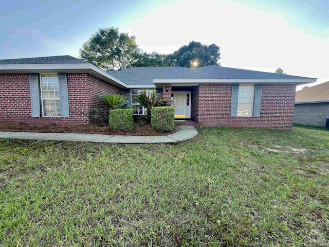 4888 La Casa Cir, Pace, FL 32571 - ranch-style home with brick siding and a front lawn