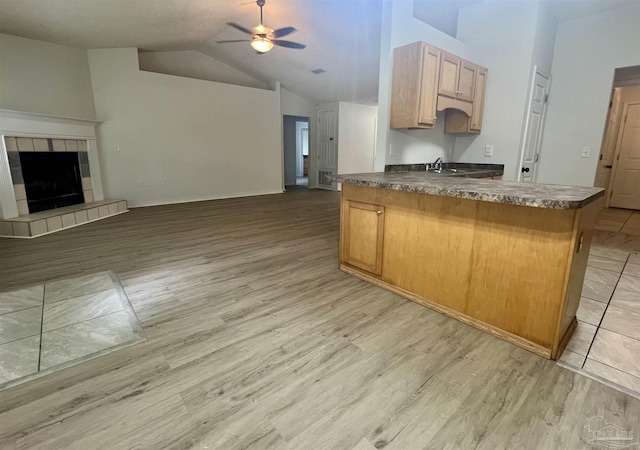 4888 La Casa Cir, Pace, FL 32571 - kitchen with open floor plan, light wood finished floors, dark countertops, ceiling fan, and vaulted ceiling