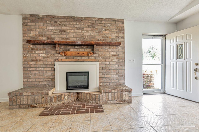 10449 Bernice Rd, Milton, FL 32583 - unfurnished living room featuring a textured ceiling, tile patterned floors, a brick fireplace, and baseboards