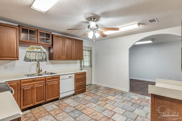10449 Bernice Rd, Milton, FL 32583 - kitchen featuring white dishwasher, a sink, a ceiling fan, arched walkways, and light stone finish floors