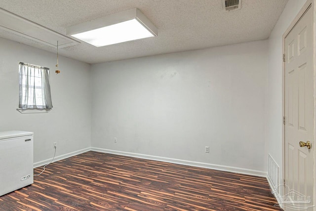 10449 Bernice Rd, Milton, FL 32583 - empty room featuring attic access, wood finished floors, a textured ceiling, and baseboards