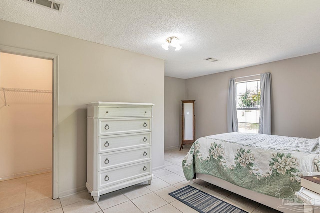 10449 Bernice Rd, Milton, FL 32583 - bedroom featuring light tile patterned floors, a textured ceiling, and baseboards
