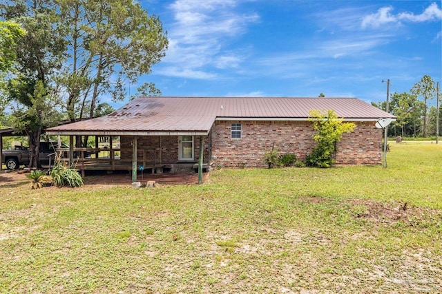 10449 Bernice Rd, Milton, FL 32583 - back of property with a lawn and metal roof