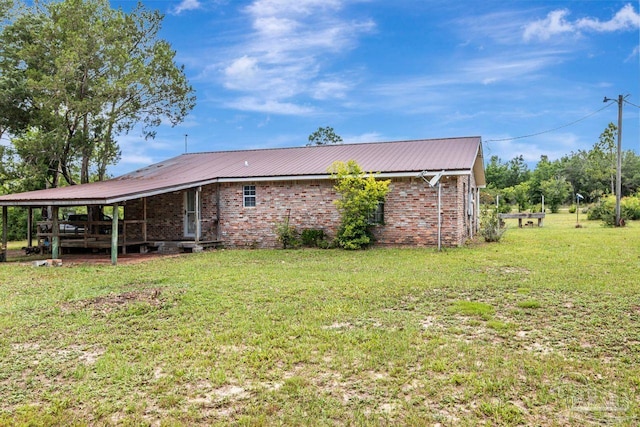 10449 Bernice Rd, Milton, FL 32583 - view of property exterior with a lawn and metal roof
