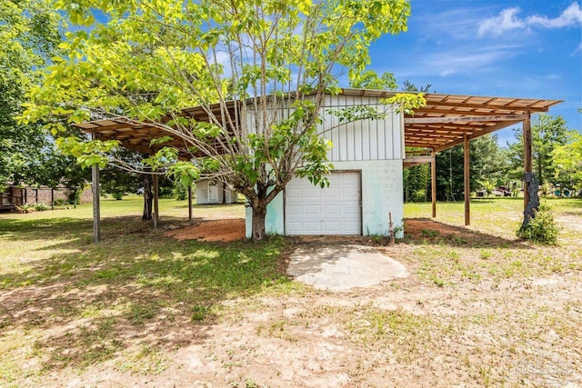 10449 Bernice Rd, Milton, FL 32583 - view of outbuilding with an attached garage, driveway, and a carport
