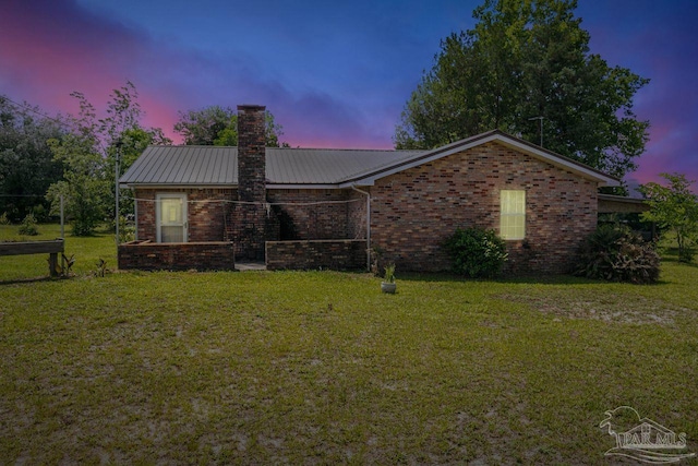 10449 Bernice Rd, Milton, FL 32583 - single story home with a chimney, brick siding, and a lawn