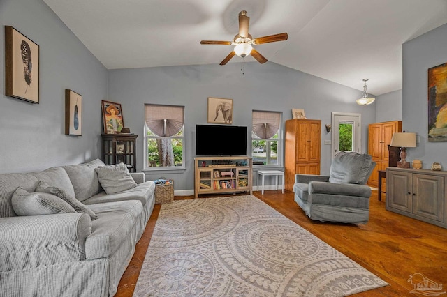 living room with ceiling fan, vaulted ceiling, wood finished floors, and a wealth of natural light
