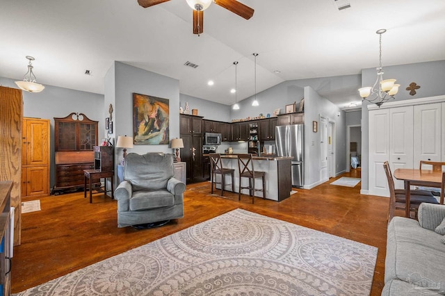 living area featuring high vaulted ceiling, visible vents, dark wood-style floors, and ceiling fan with notable chandelier