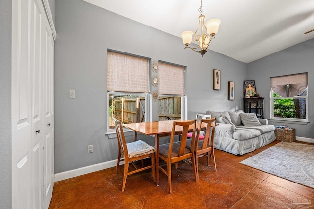 dining space with an inviting chandelier, baseboards, finished concrete flooring, and vaulted ceiling