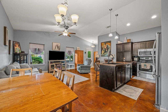 kitchen with a kitchen breakfast bar, dark brown cabinetry, appliances with stainless steel finishes, a sink, and open floor plan