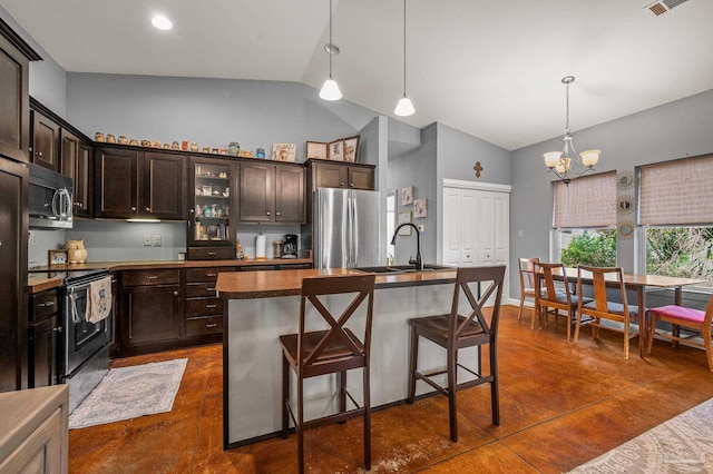 kitchen with dark countertops, a sink, high vaulted ceiling, concrete floors, and stainless steel appliances