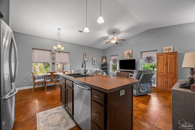 kitchen with a sink, vaulted ceiling, a wealth of natural light, and stainless steel appliances