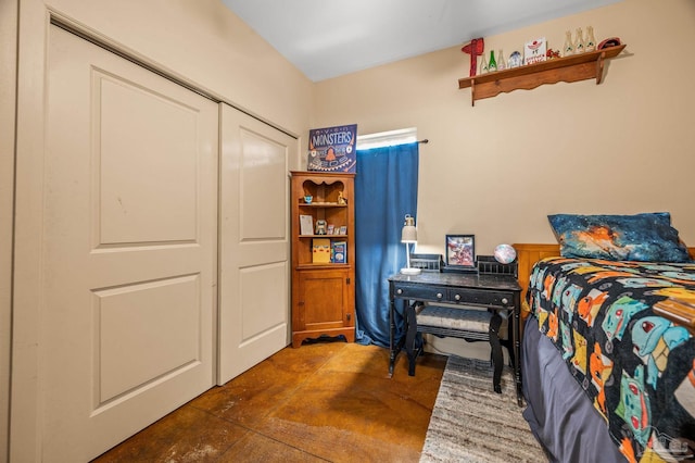bedroom with a closet and concrete flooring