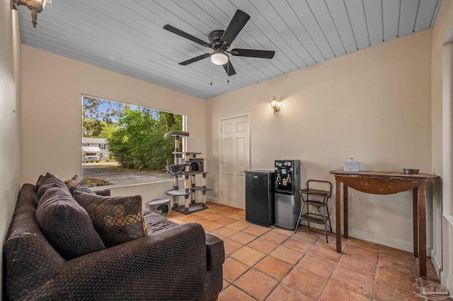 living room featuring a ceiling fan and wood ceiling