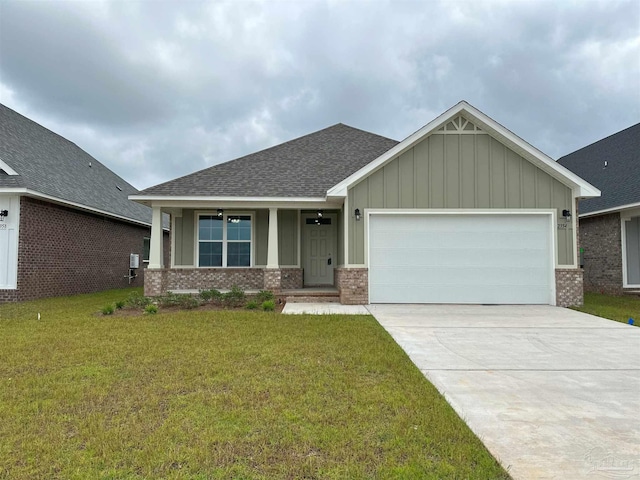 craftsman inspired home featuring a front yard and a garage