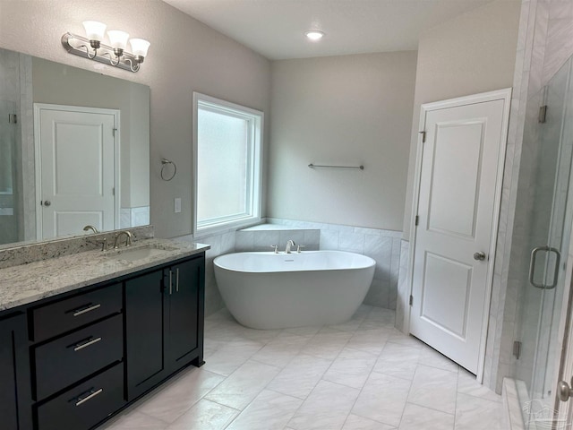 bathroom featuring shower with separate bathtub, tile walls, and vanity