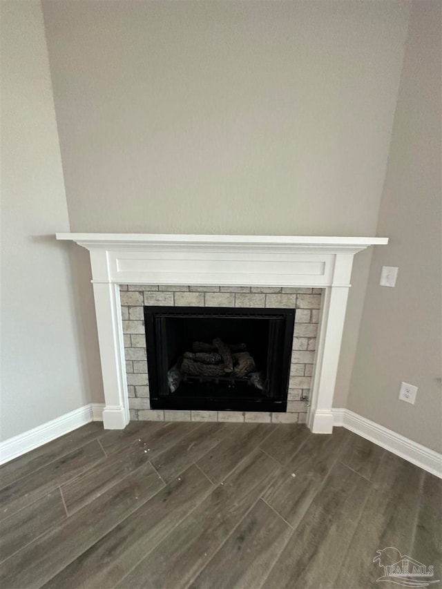 details featuring wood-type flooring and a brick fireplace