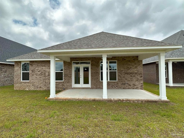 rear view of property featuring a patio and a yard