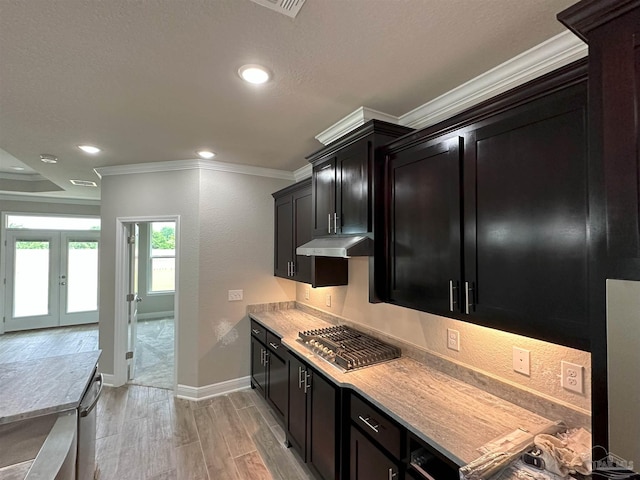 kitchen with french doors, crown molding, light hardwood / wood-style floors, and stainless steel gas cooktop