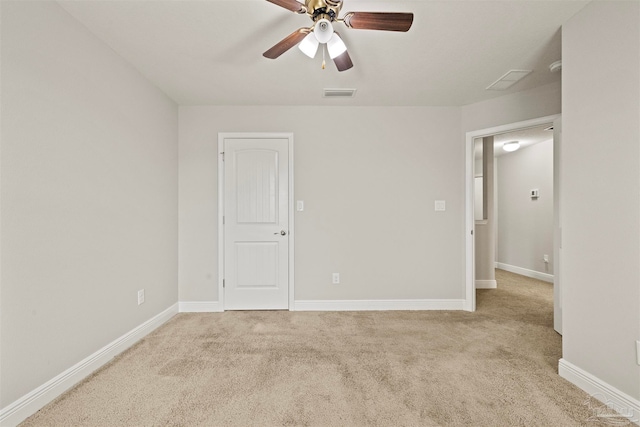 carpeted spare room with ceiling fan