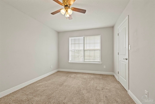 spare room featuring ceiling fan and light colored carpet