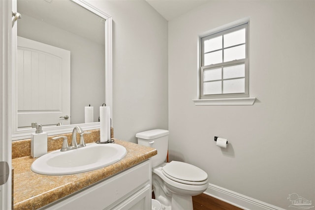 bathroom featuring hardwood / wood-style flooring, vanity, and toilet