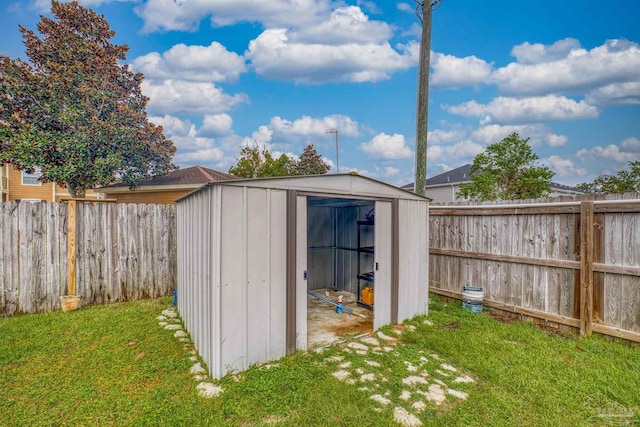 view of outbuilding featuring a lawn