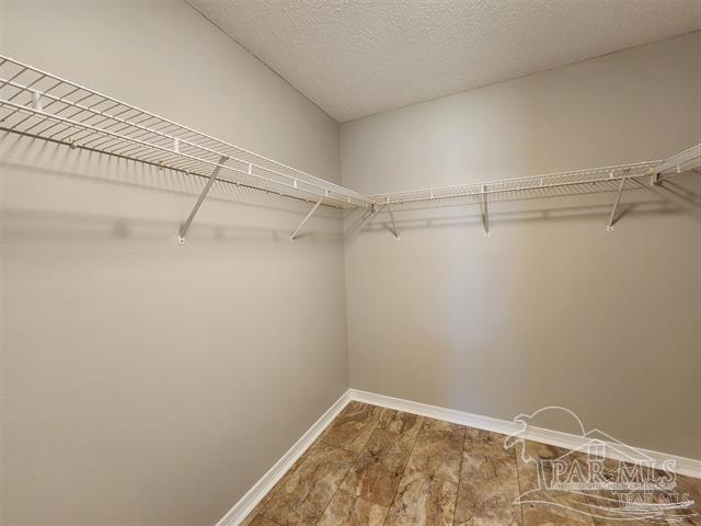 spacious closet with wood-type flooring