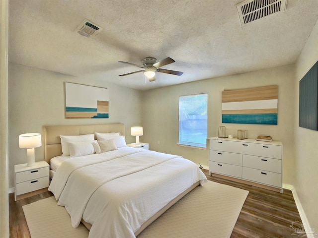 8037 Nalo Creek Loop, Pensacola, FL 32514 - bedroom featuring dark wood-style floors, a ceiling fan, and a textured ceiling