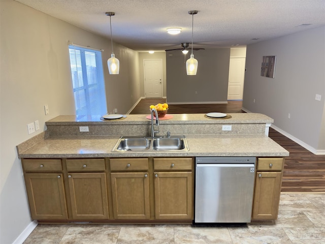 kitchen featuring a textured ceiling, ceiling fan, sink, dishwasher, and hanging light fixtures