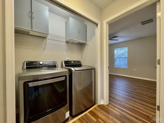 laundry area featuring hardwood / wood-style floors, washer and dryer, ceiling fan, and a textured ceiling