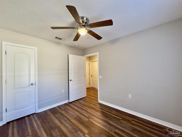 8037 Nalo Creek Loop, Pensacola, FL 32514 - unfurnished bedroom with dark wood-style floors, a textured ceiling, and a ceiling fan