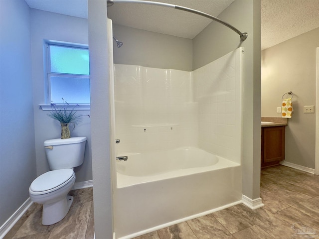 full bathroom with bathing tub / shower combination, vanity, a textured ceiling, and toilet