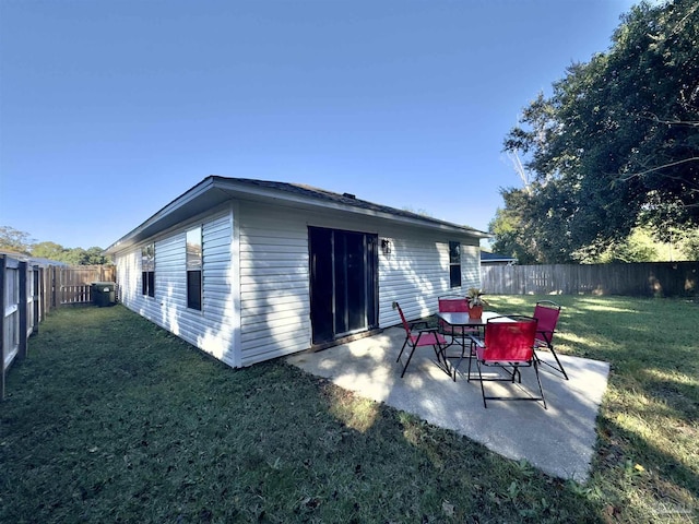 back of property featuring a yard and a patio area