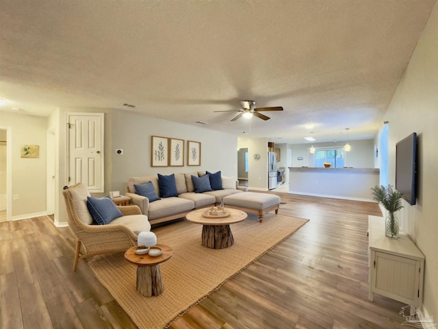 8037 Nalo Creek Loop, Pensacola, FL 32514 - living room with wood finished floors, a ceiling fan, and a textured ceiling