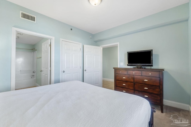 carpeted bedroom featuring connected bathroom