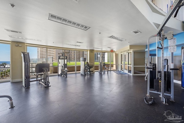 gym with a wall of windows and a textured ceiling