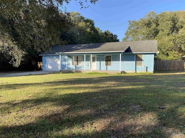 ranch-style home featuring covered porch, a garage, and a front lawn