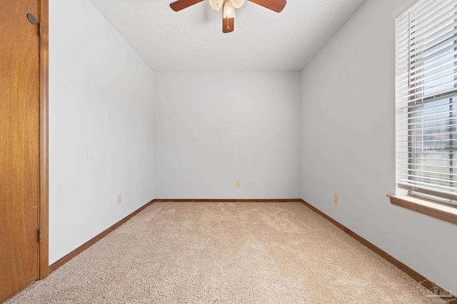 unfurnished room featuring light carpet, a textured ceiling, and ceiling fan