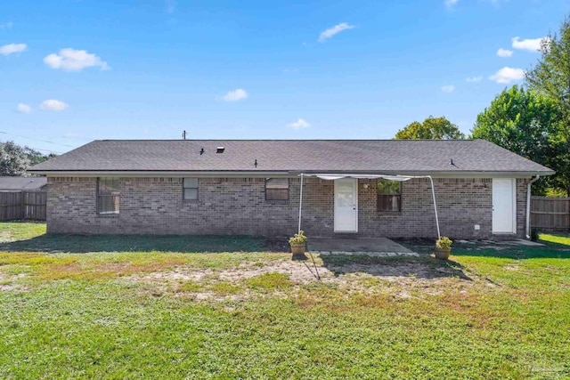 rear view of house with a yard